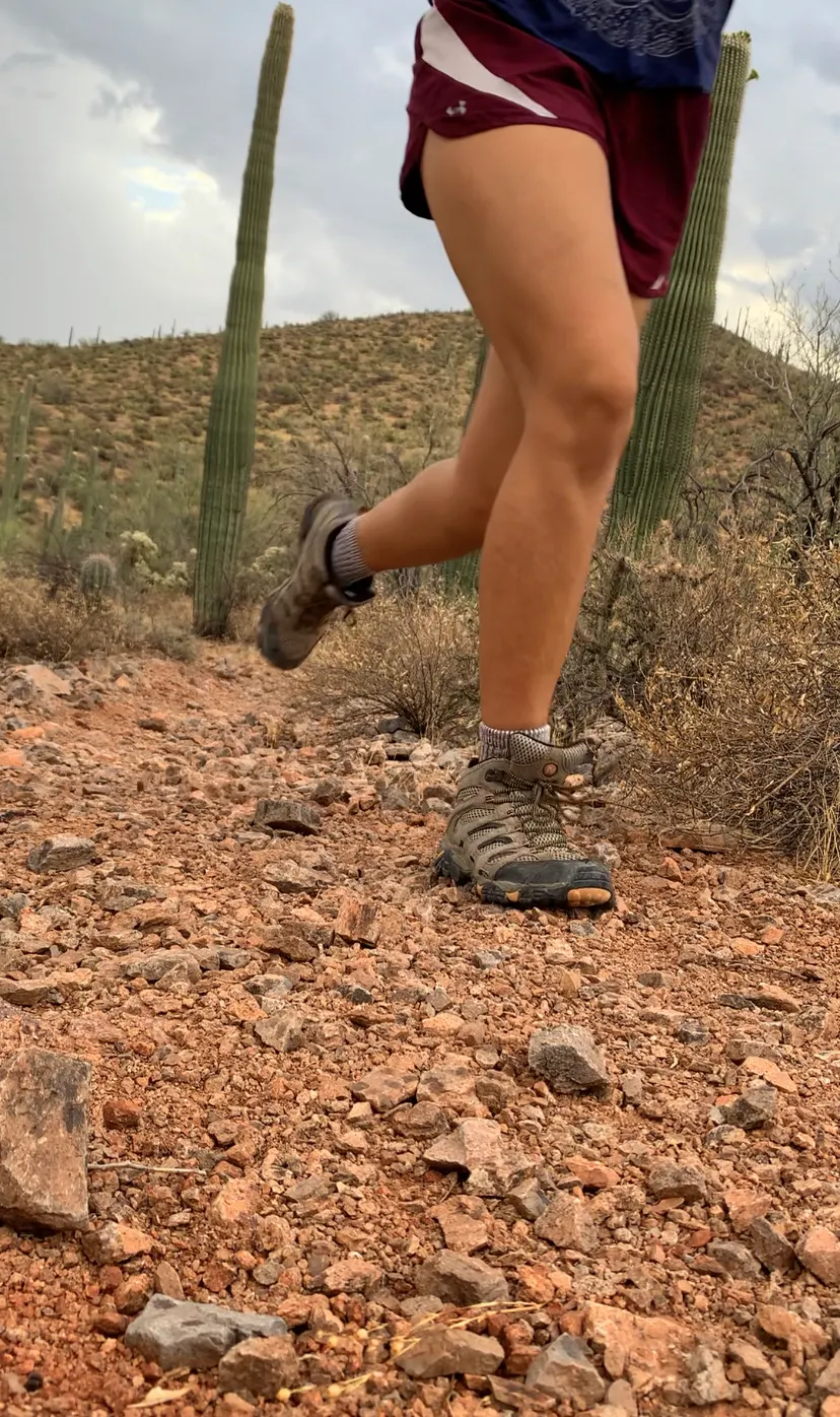 Trail runner on rocky desert terrain, illustrative image