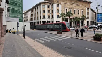 A red Casablanca tram passing Bank Al-Maghrib in the city centre